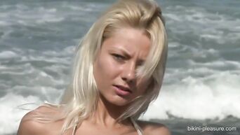 Pornstar Pinky June shows a delightful striptease on the beach