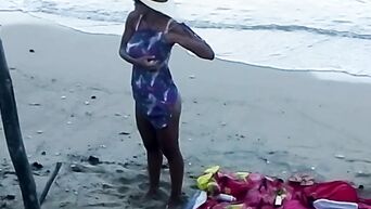 Spying on nudist beach on black MILF