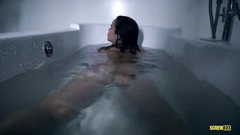 Dark-haired pornstar experiences orgasm from masturbation in the bath